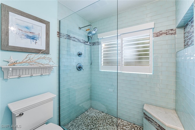 bathroom featuring toilet and tiled shower