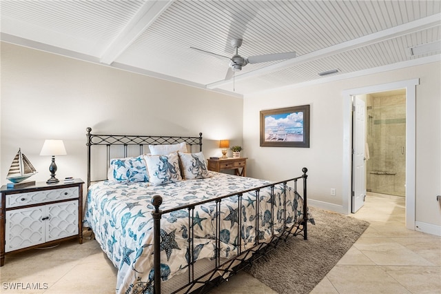 bedroom with ceiling fan, beam ceiling, light tile patterned floors, and ensuite bath