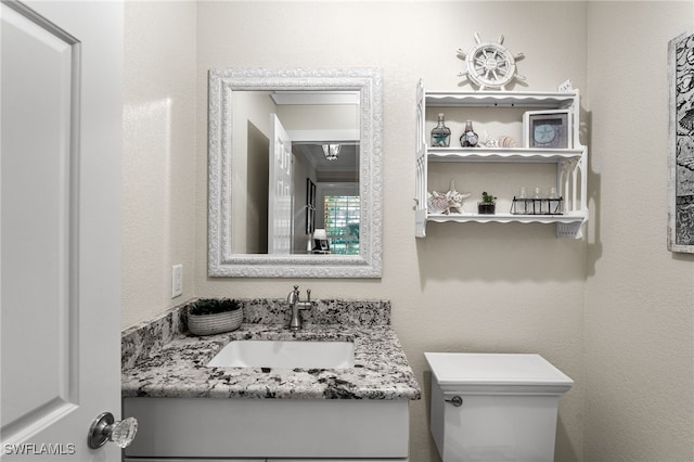 bathroom featuring toilet and vanity