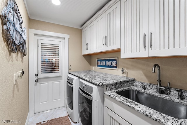 washroom with cabinets, sink, washer and clothes dryer, and light tile patterned flooring