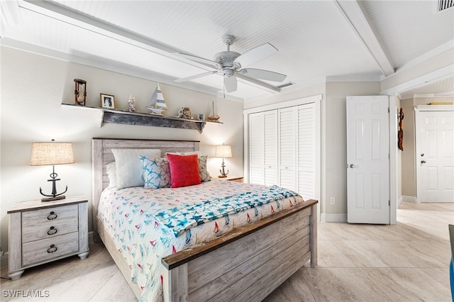 bedroom featuring ceiling fan, light tile patterned floors, a closet, and beam ceiling