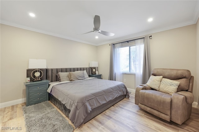 bedroom with ceiling fan, crown molding, and light hardwood / wood-style flooring