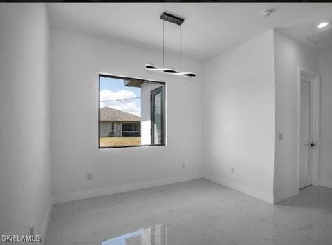 unfurnished dining area featuring marble finish floor