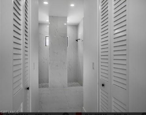 bathroom with recessed lighting, a closet, and a marble finish shower