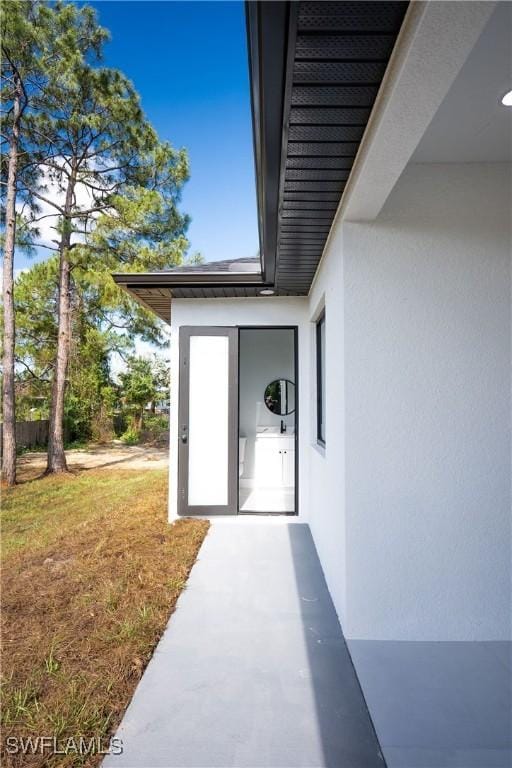 1254 Ellipse St E, Lehigh Acres, FL 33974 - entrance to property with stucco siding and a yard