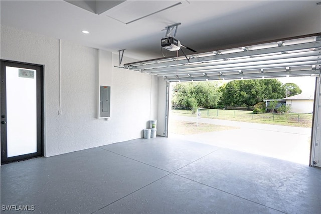 1254 Ellipse St E, Lehigh Acres, FL 33974 - garage with a garage door opener, a textured wall, and electric panel