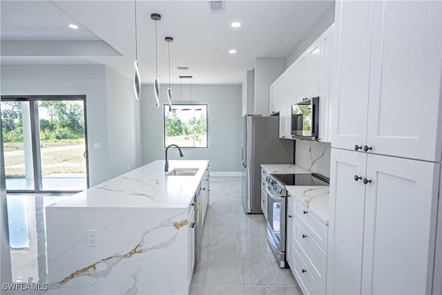 1254 Ellipse St E, Lehigh Acres, FL 33974 - kitchen featuring visible vents, an island with sink, recessed lighting, a sink, and stainless steel appliances