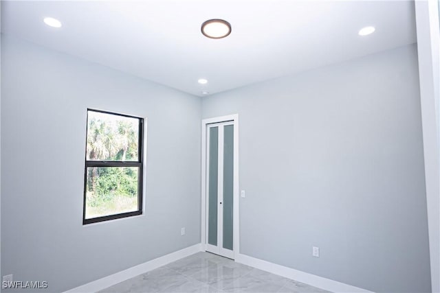 1254 Ellipse St E, Lehigh Acres, FL 33974 - spare room featuring baseboards, recessed lighting, and marble finish floor