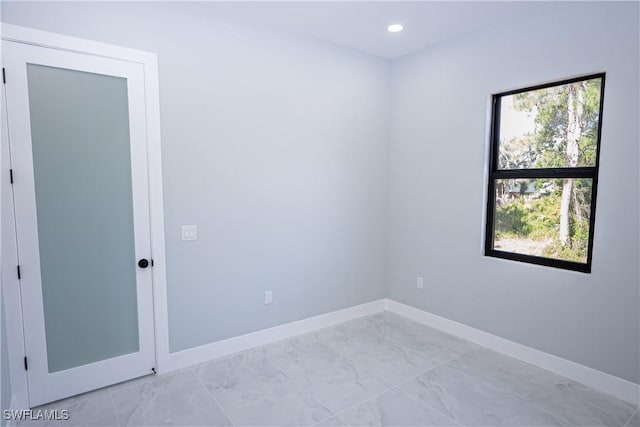 1254 Ellipse St E, Lehigh Acres, FL 33974 - empty room with baseboards, recessed lighting, and marble finish floor