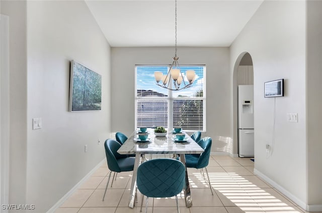 dining space featuring a notable chandelier and light tile patterned floors