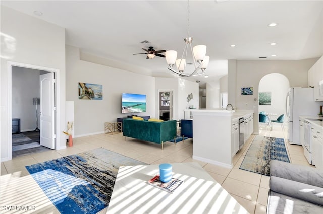 living room featuring light tile patterned floors and ceiling fan with notable chandelier