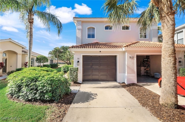 mediterranean / spanish-style home with a garage