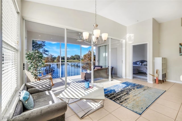 living room with a water view, light tile patterned floors, and a notable chandelier