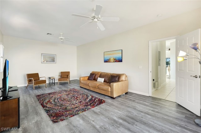 living room featuring ceiling fan and light wood-type flooring