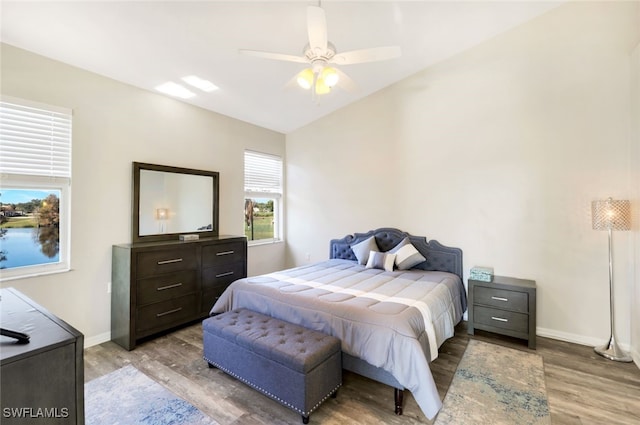 bedroom with ceiling fan and light hardwood / wood-style floors