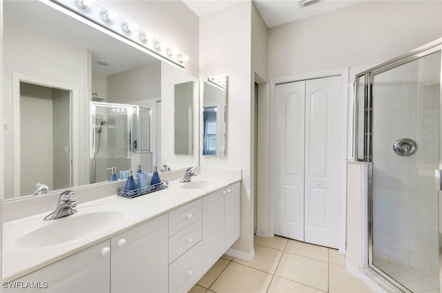 bathroom with an enclosed shower, vanity, and tile patterned floors