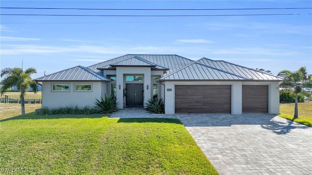 view of front of house with a garage and a front lawn