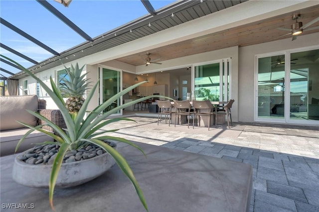 view of patio / terrace featuring ceiling fan and a lanai