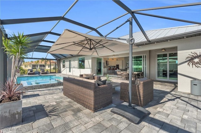 view of patio / terrace featuring ceiling fan, outdoor lounge area, and a lanai