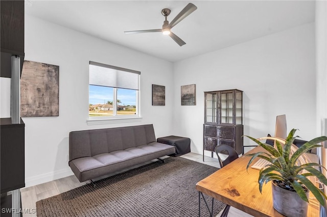 living room with hardwood / wood-style flooring and ceiling fan