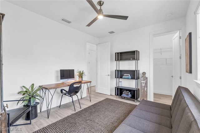 office area with light hardwood / wood-style flooring and ceiling fan