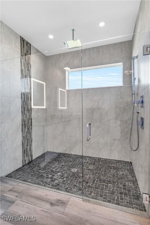 bathroom featuring a healthy amount of sunlight and an enclosed shower