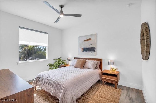 bedroom with ceiling fan and light hardwood / wood-style floors