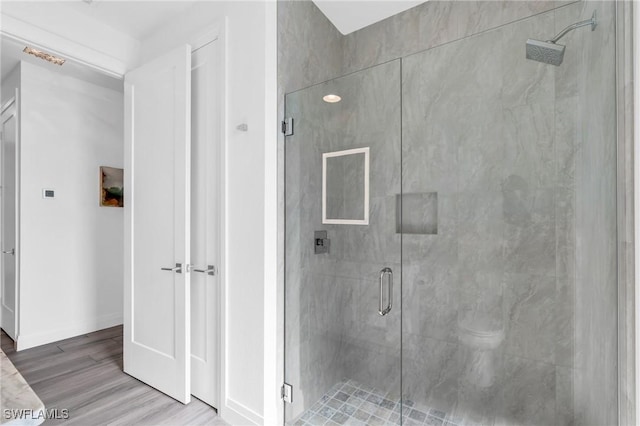 bathroom with hardwood / wood-style floors and walk in shower