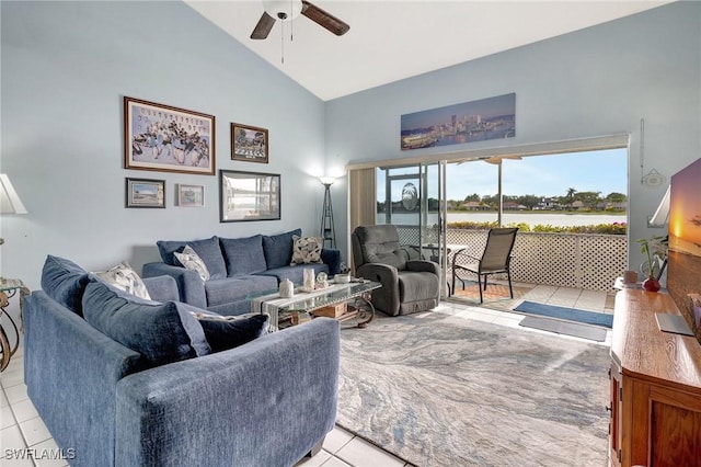 tiled living room featuring ceiling fan and high vaulted ceiling