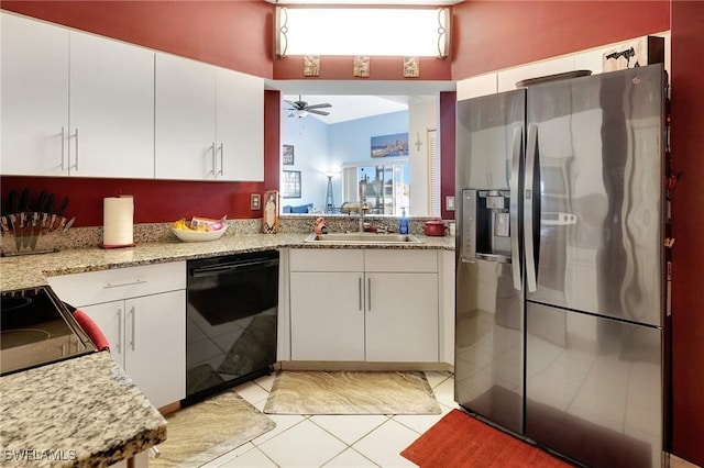 kitchen featuring light stone countertops, white cabinets, stainless steel refrigerator with ice dispenser, black dishwasher, and sink