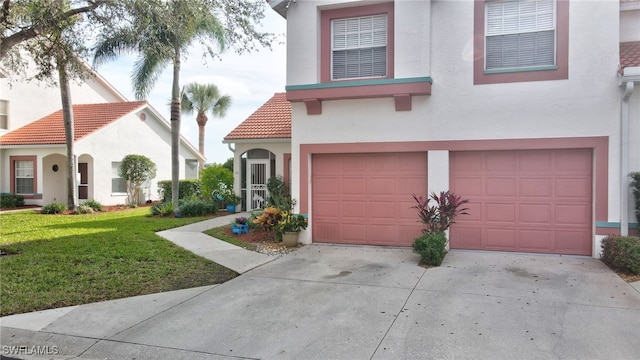 view of front of home with a garage and a front lawn