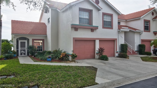 view of front of property with a garage and a front yard