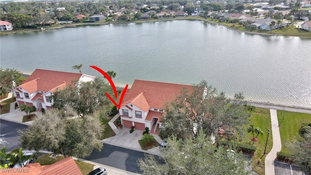 birds eye view of property with a water view