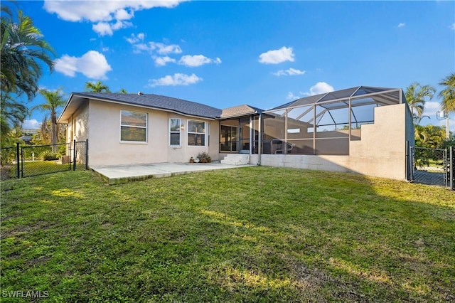 back of house featuring a lanai, a patio, and a lawn