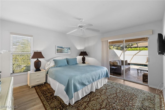 bedroom with multiple windows, access to exterior, and ceiling fan