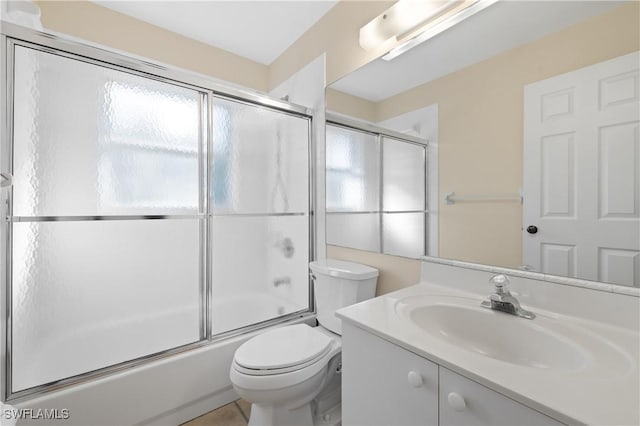 full bathroom featuring toilet, enclosed tub / shower combo, a wealth of natural light, and vanity