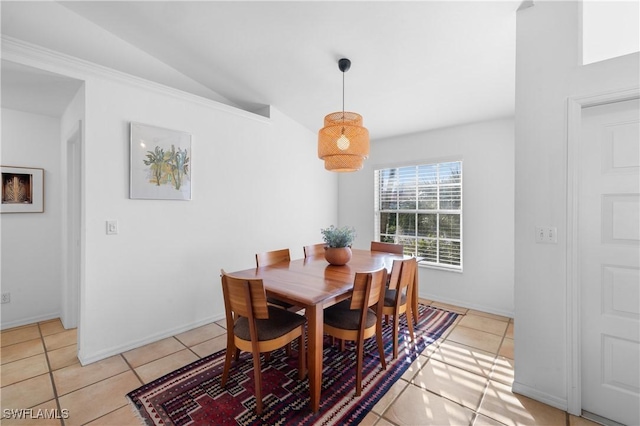 tiled dining space with vaulted ceiling