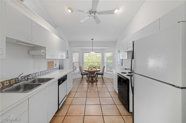 kitchen with sink, white cabinetry, white fridge, black electric range oven, and stainless steel dishwasher