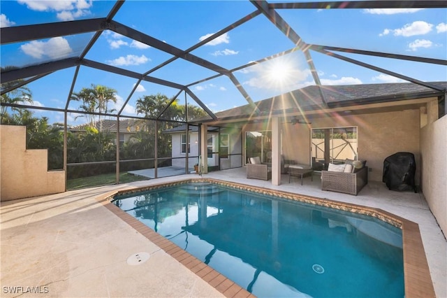 view of swimming pool with a lanai, a patio area, and an outdoor living space