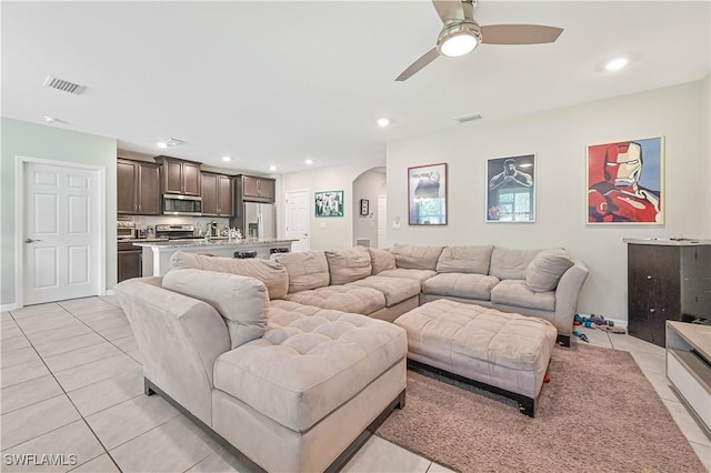 tiled living room with ceiling fan