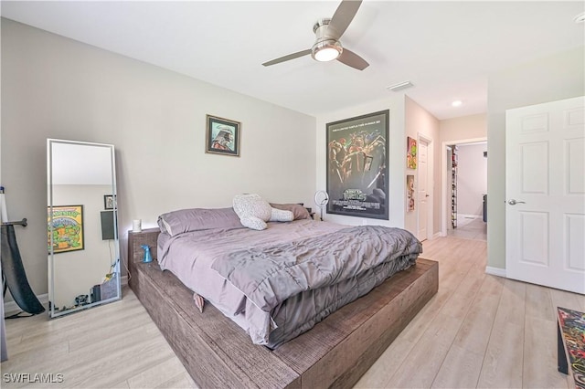 bedroom featuring connected bathroom, ceiling fan, and light hardwood / wood-style floors