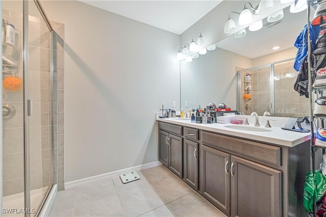 bathroom with an enclosed shower, tile patterned flooring, and vanity