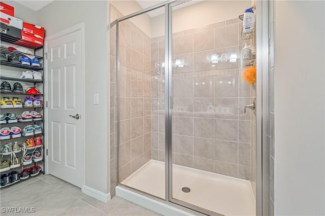 bathroom with tile patterned floors and a shower with shower door