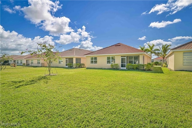 back of house featuring a yard