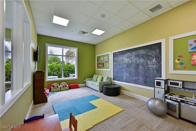 exercise room featuring a drop ceiling