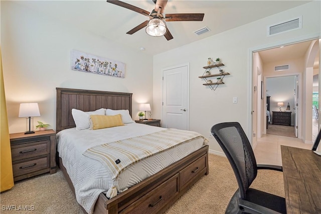 bedroom with ceiling fan and light carpet