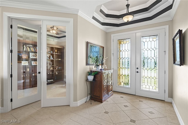 foyer entrance featuring french doors, crown molding, and light tile patterned floors