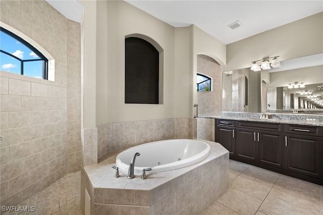 bathroom featuring tile patterned floors, vanity, and shower with separate bathtub