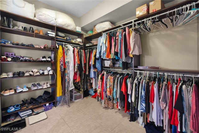 spacious closet with light tile patterned floors