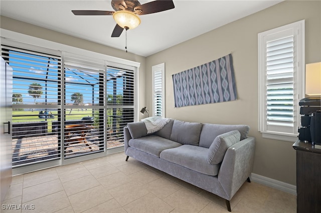 living room featuring ceiling fan and light tile patterned floors